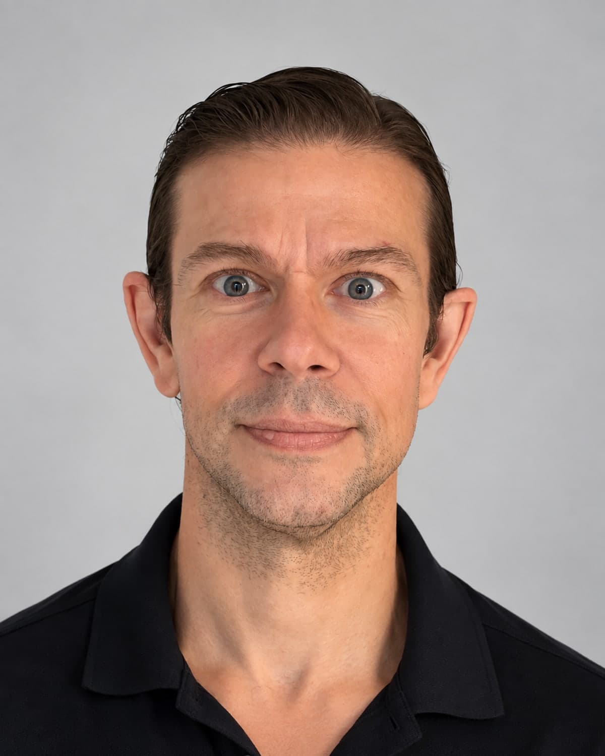 Dr. David Spranklin in a dark polo shirt, smiling to camera