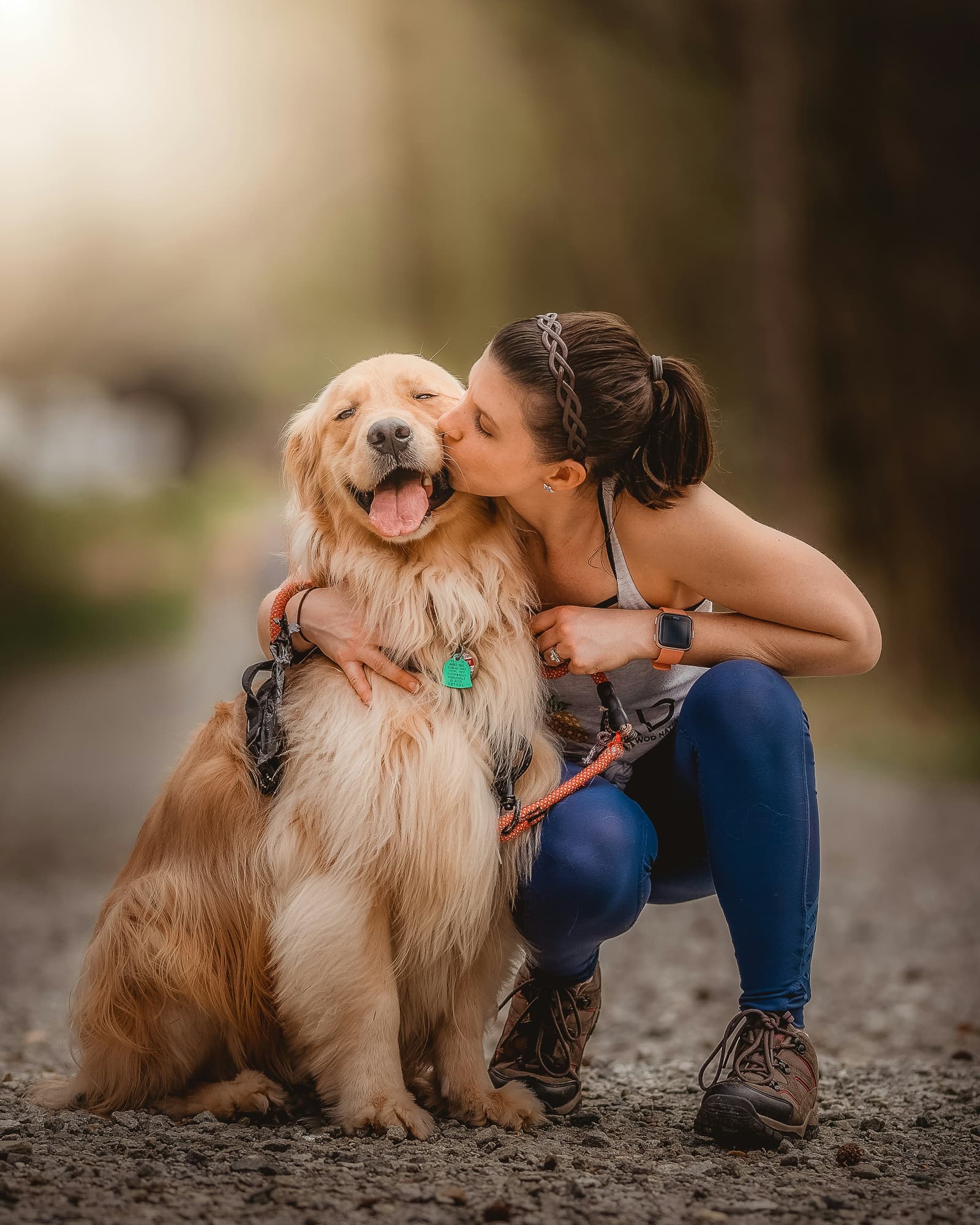 A person embracing their dog outdoors